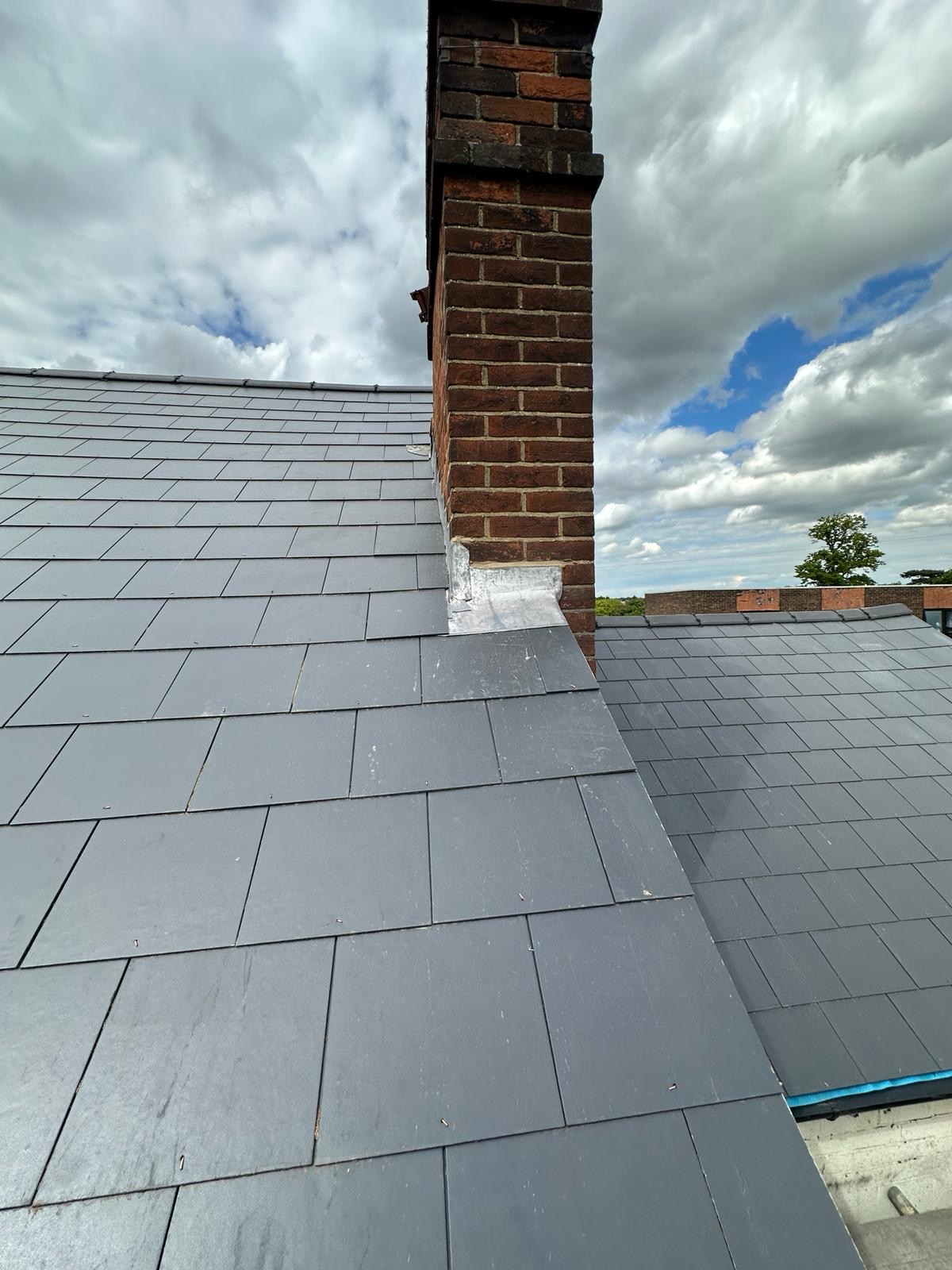 Valley detail where two slate pitches meet at a central brick chimney