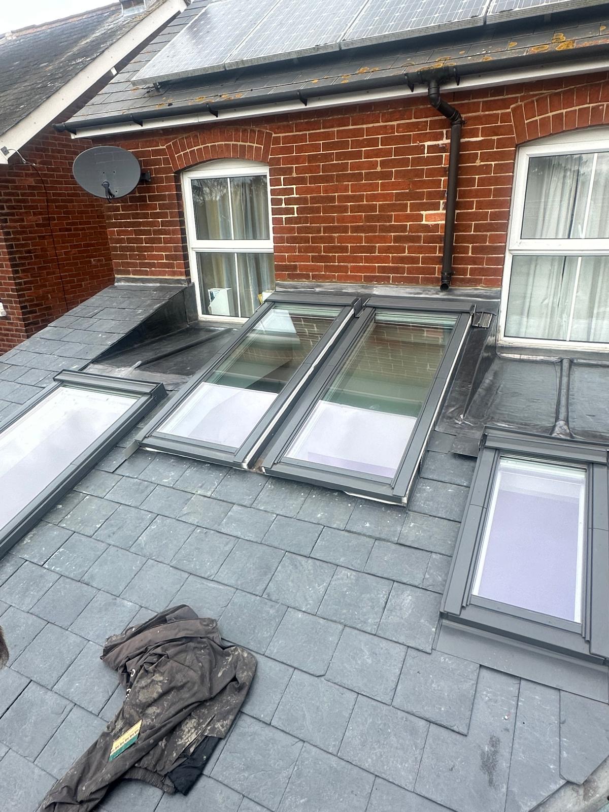 Multi-skylight installation on a slate roof of a Suffolk brick home