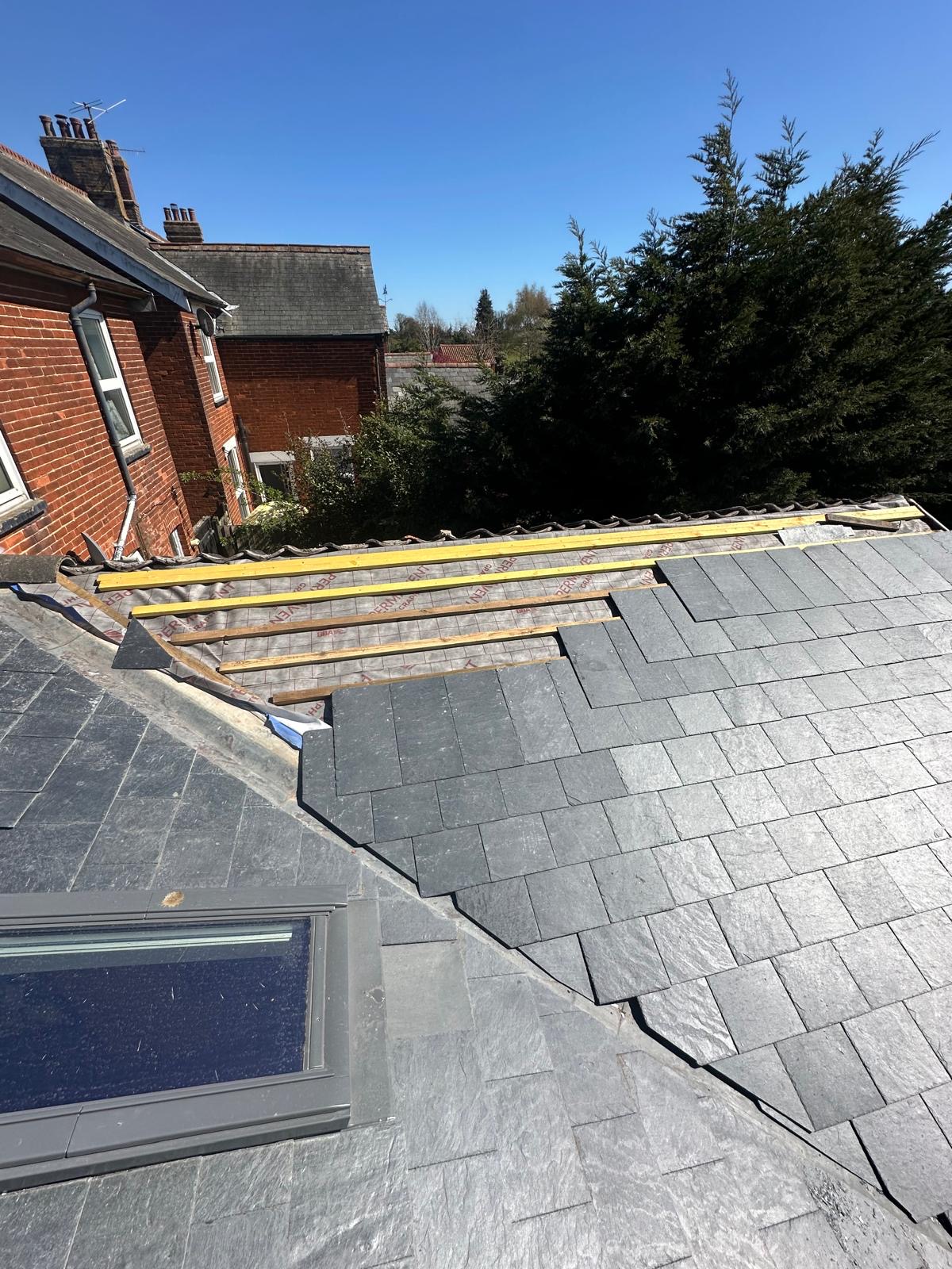 Nearly complete slate roof showing precise hip detail and clean lines