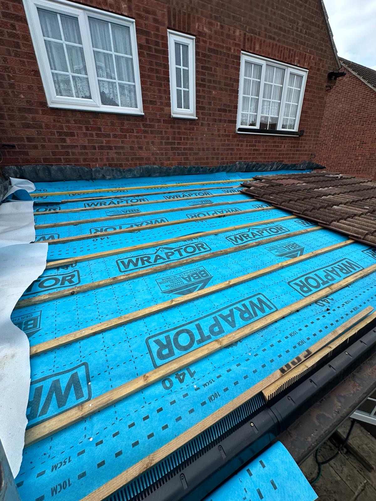 Full pitch of blue Wraptor breather membrane and treated battens ready for tiles