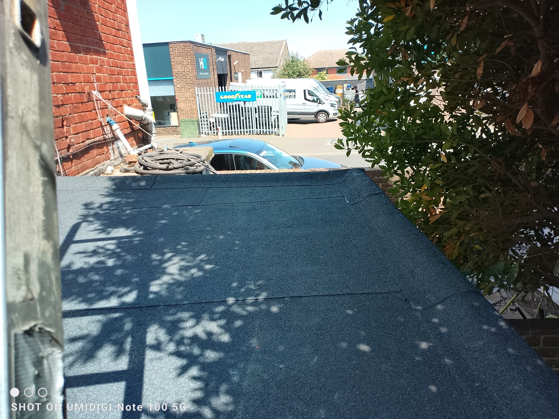 Neat finished torch-on felt flat roof with crisp edge trims and drip detail