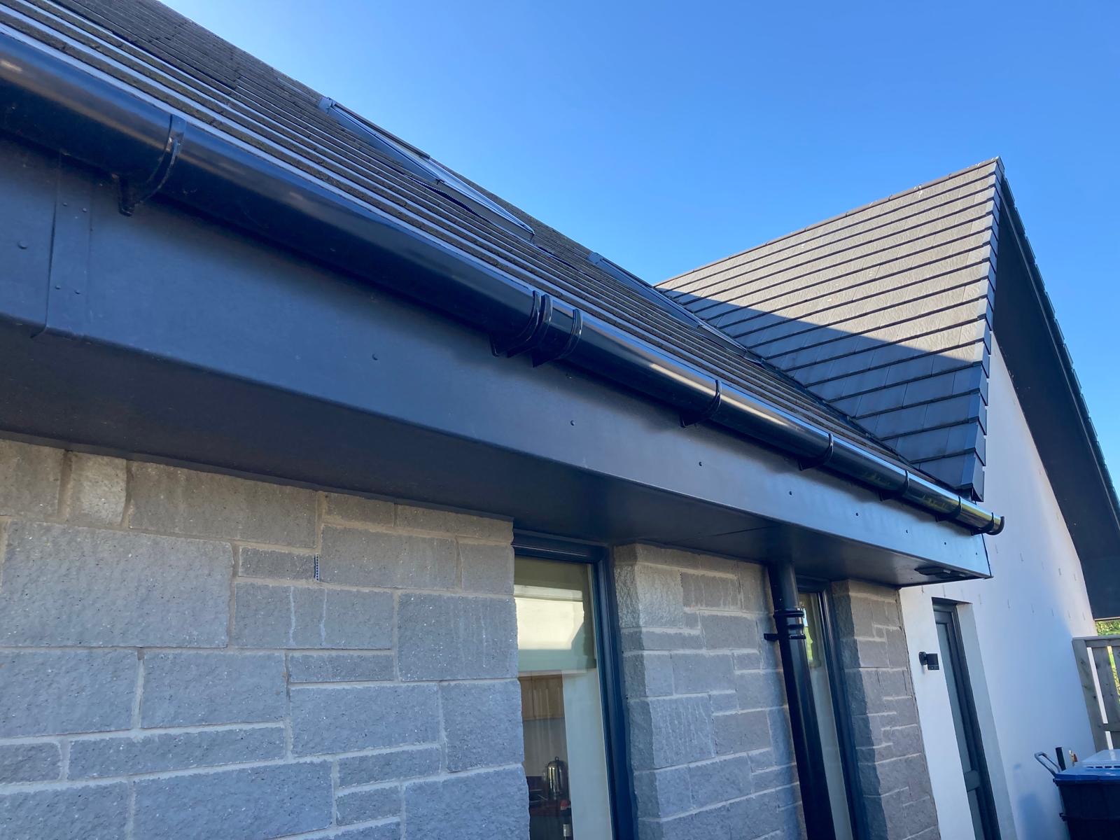 New fascia, soffits and black gutters on a modern slate roof