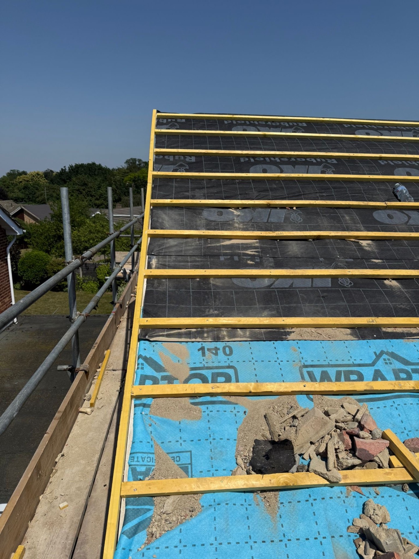Fresh Wraptor membrane and treated battens on a full re-roof beside chimney