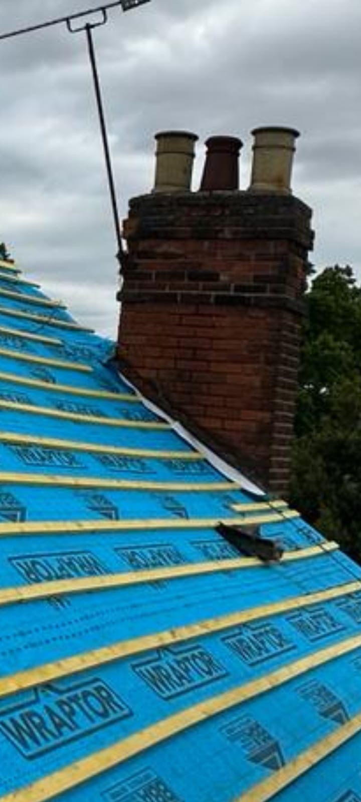 Wraptor membrane hip detail beneath ornate chimney pots