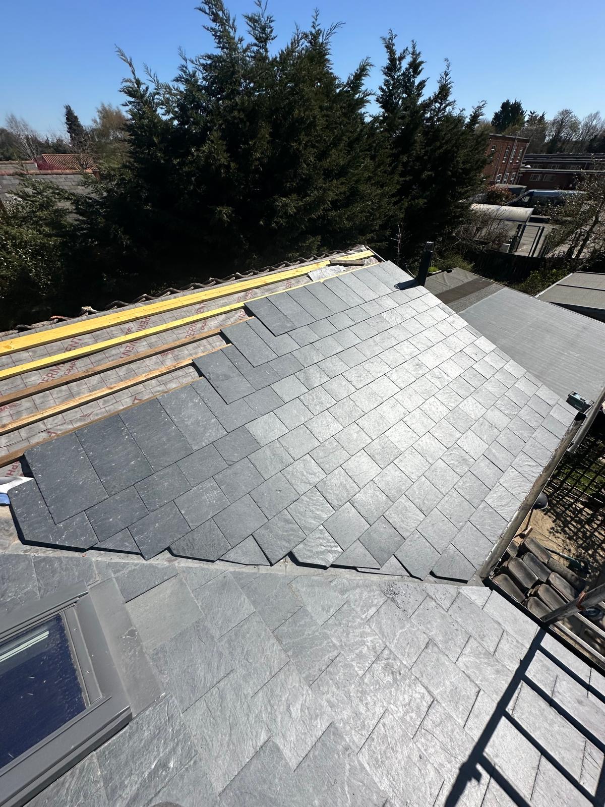 Half-laid slate roof revealing timber battens and craftsmanship in progress