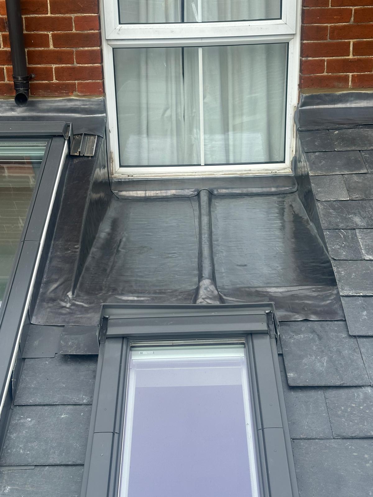 Neat lead flashing detail dressed between skylight, brickwork and window