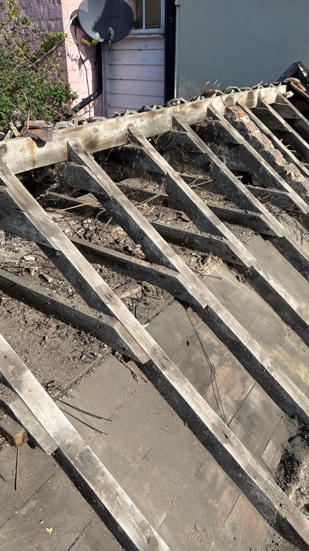 Stripped roof exposing timber rafters ready for full re-roof
