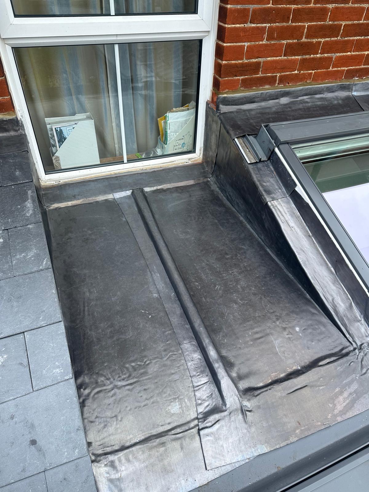 EPDM rubber flat roof with slate surround and skylight