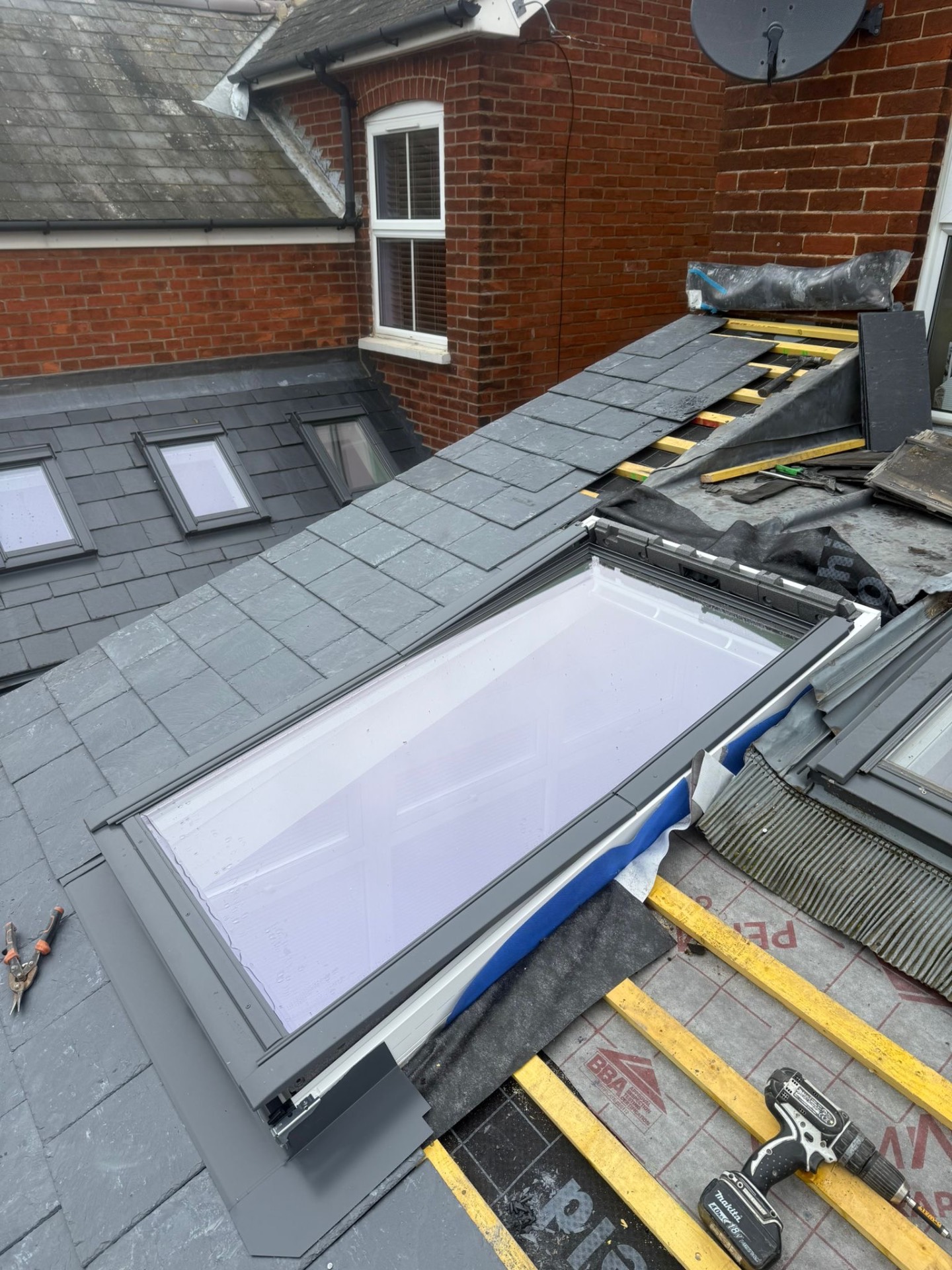 Velux skylight installed into new slate pitched roof with lead flashing