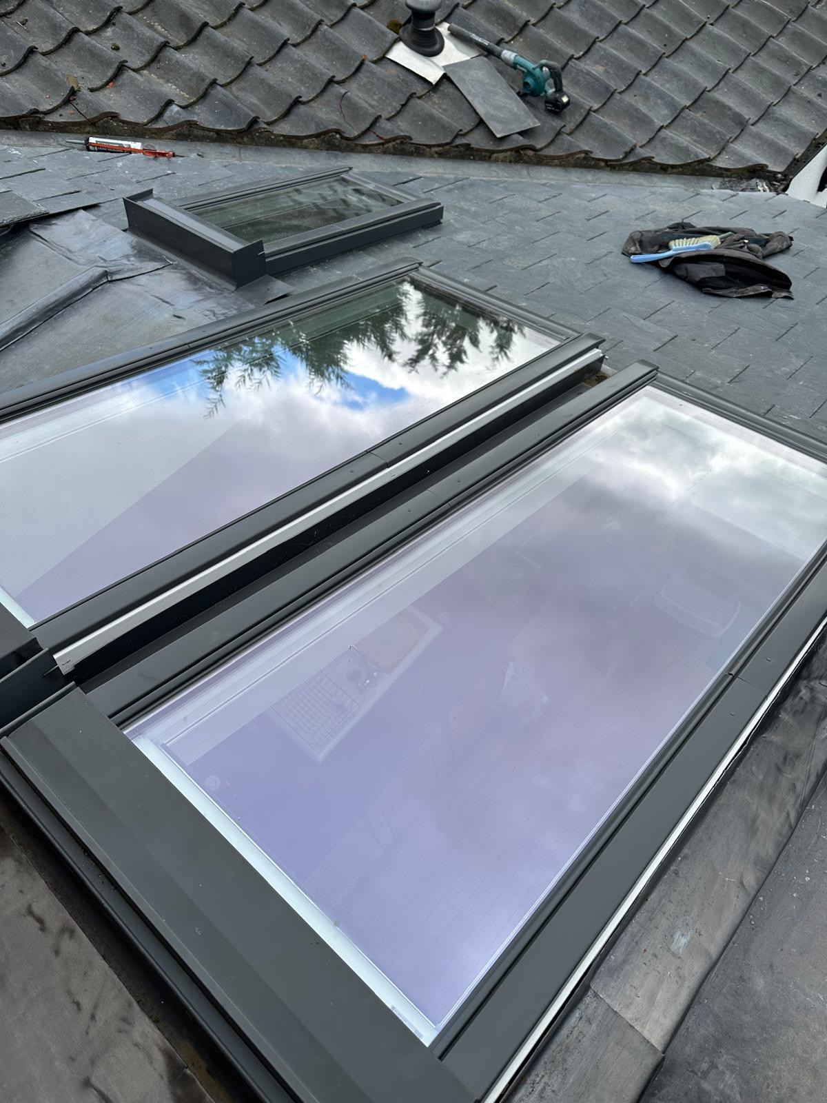 Twin Velux skylights freshly fitted into a grey slate pitched roof