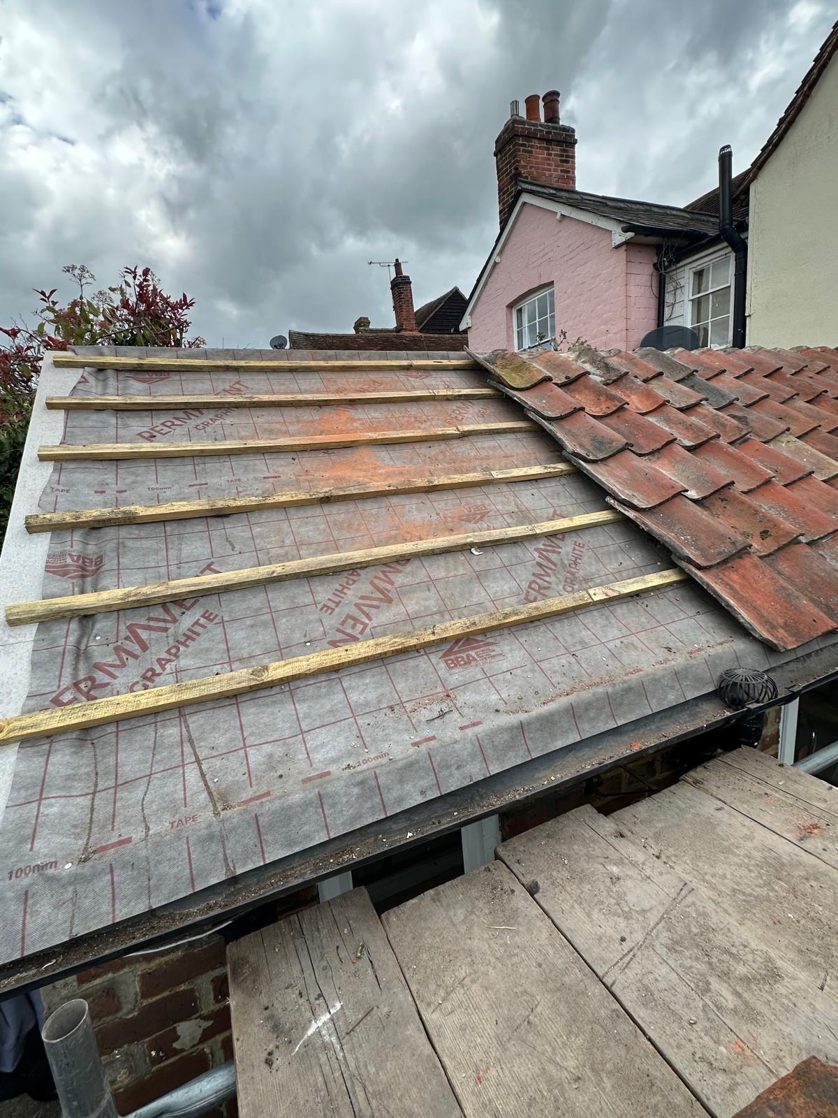Close-up of red clay roof tiles and ridge detail